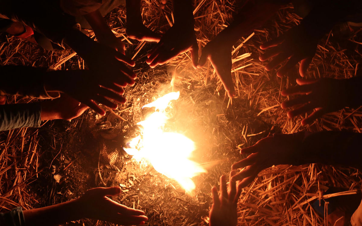 People warming up lighting a fire with hay at Collegepara, Khagrachhari on 25 January. Photo: Nerob Chowdhury