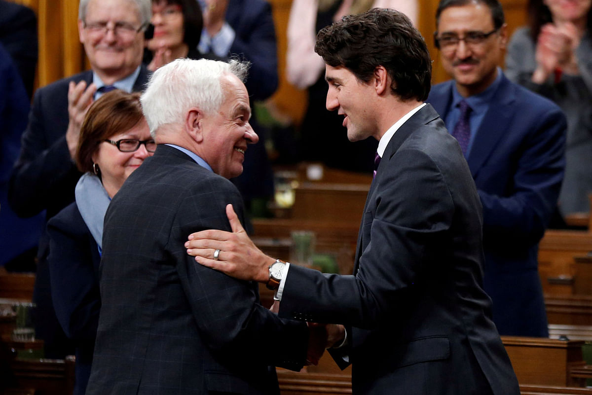 Canada`s prime minister Justin Trudeau (R) shakes hands with former immigration minister John McCallum after McCallum delivered his farewell speech in the House of Commons on Parliament Hill in Ottawa, Ontario, Canada, on 31 January 2017. Reuters File Photo