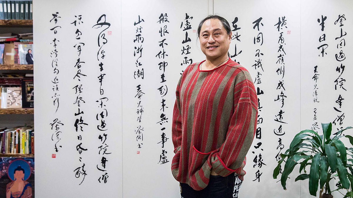 This picture taken on 19 January 2019 shows feng shui master Alion Yeo posing for a photo in his office in Hong Kong ahead of the Lunar New Year of the Pig. Photo: AFP