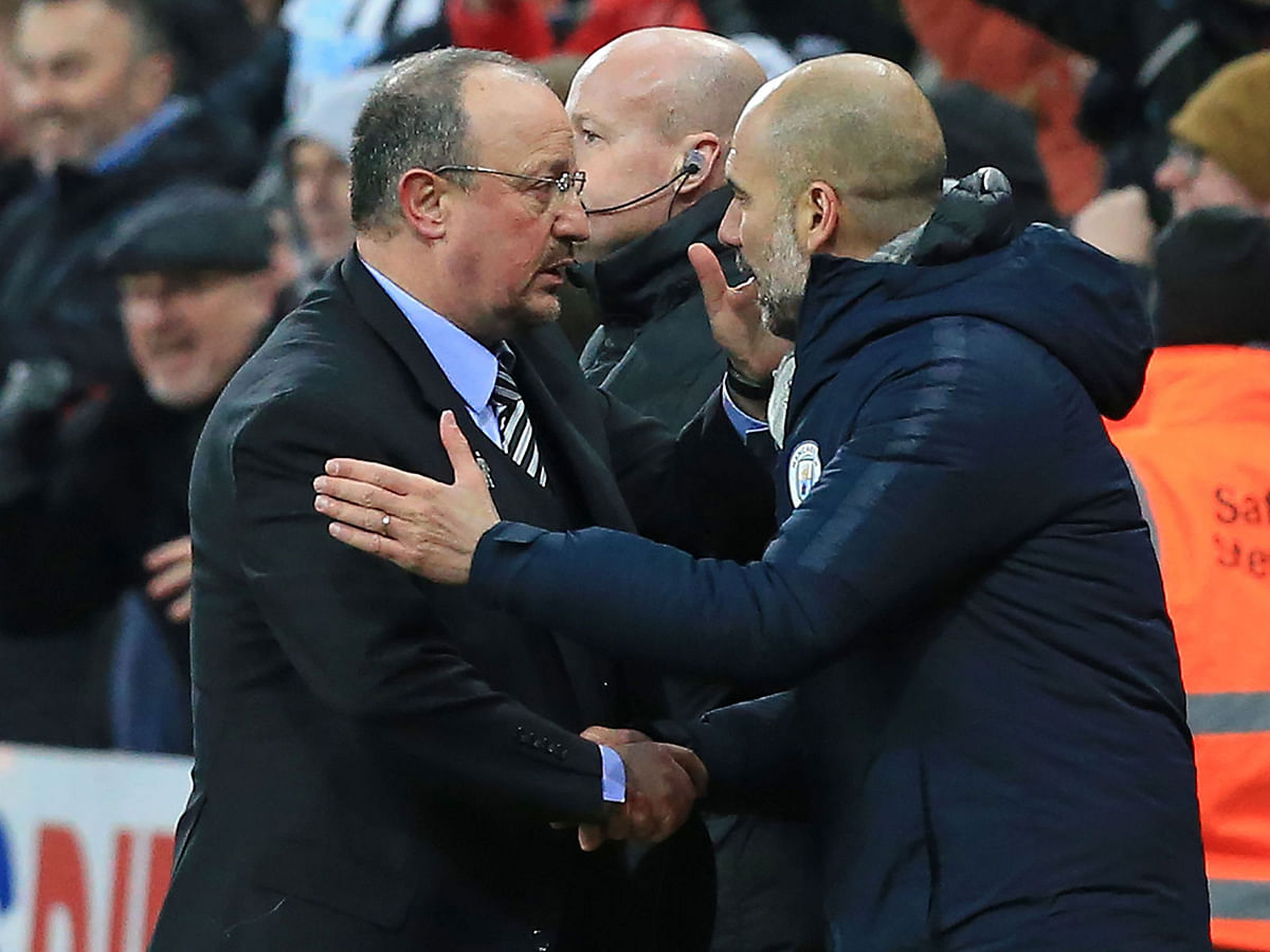 Newcastle United`s Spanish manager Rafael Benitez (L) shakes hands with Manchester City`s Spanish manager Pep Guardiola (R) after the English Premier League football match between Newcastle United and Manchester City at St James` Park in Newcastle-upon-Tyne, north east England on 29 January 2019. Photo: AFP