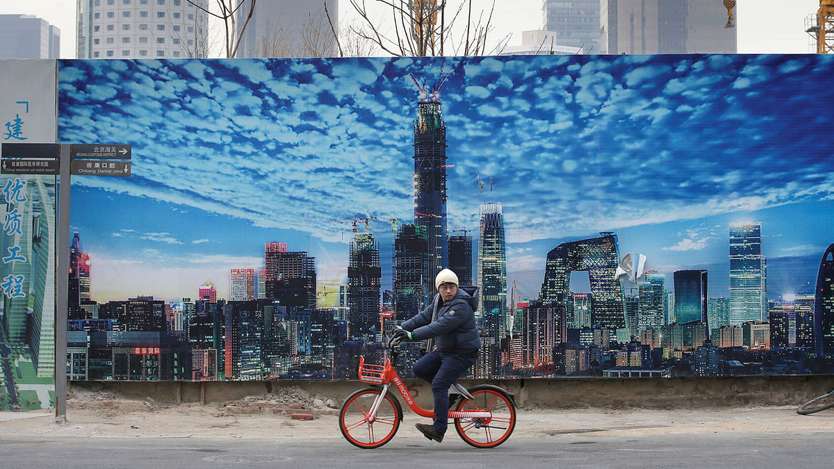A man cycles outside the construction sites in Beijing`s central business area, China. Picture taken 18 January 2019. Photo: Reuters