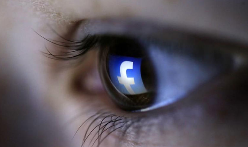 A picture illustration shows a Facebook logo reflected in a person`s eye, in Zenica, on 13 March 2015. -- Photo: Reuters