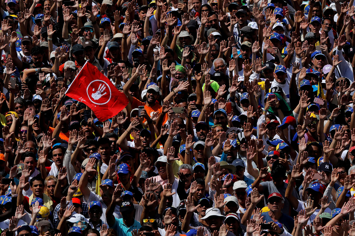 Demonstrators raise their hands during a protest against Venezuelan president Nicolas Maduro`s government in Caracas, Venezuela on 2 February 2019. Photo: Reuters
