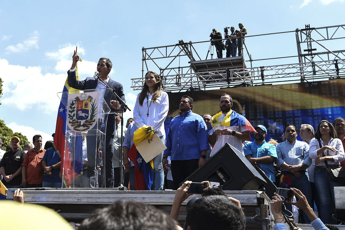 Opposition leader Juan Guaido (L) gestures next to his wife Fabiana Rosales as he delivers a speech before thousands of supporters, in Caracas on 2 February 2019. Photo: AFP
