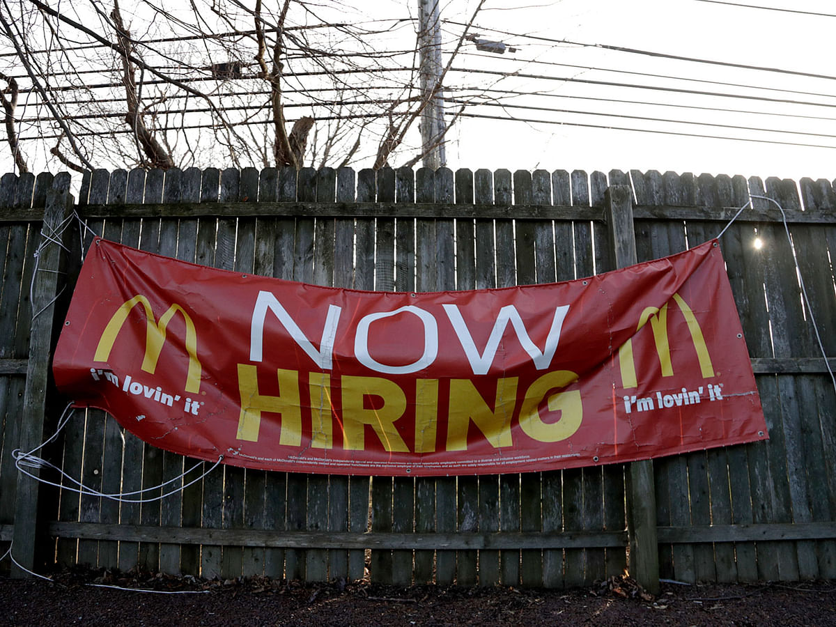 In this 3 January 2019, file photo an employment sign hangs from a wooden fence on the property of a McDonald`s restaurant in Atlantic Highlands. Photo: AP