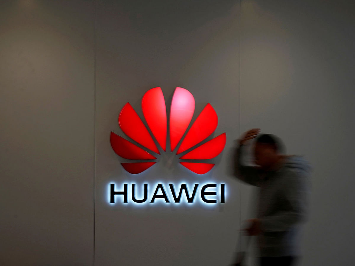 A man walks by a Huawei logo at a shopping mall in Shanghai, China, on 6 December 2018. Reuters File Photo
