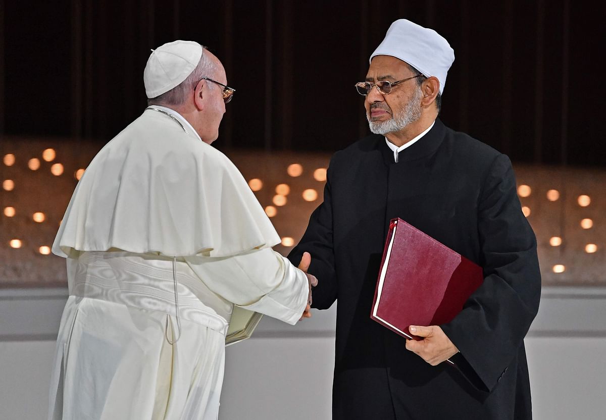 Pope Francis (L) and Egypt`s Azhar Grand Imam Sheikh Ahmed al-Tayeb greet each other as they exchange documents during the Human Fraternity Meeting at the Founders Memorial in Abu Dhabi on 4 February. Photo: AFP