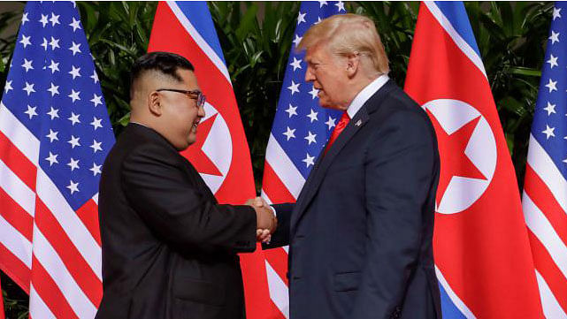 US president Donald Trump and North Korean leader Kim Jong Un walk after lunch at the Capella Hotel on Sentosa island in Singapore on 12 June 2018. Photo: Reuters