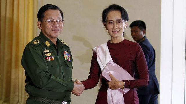 Myanmar Commander-in-Chief Min Aung Hlaing shakes hands with National League for Democracy (NLD) party leader Aung San Suu Kyi before their meeting in Naypyitaw. Reuters File Photo