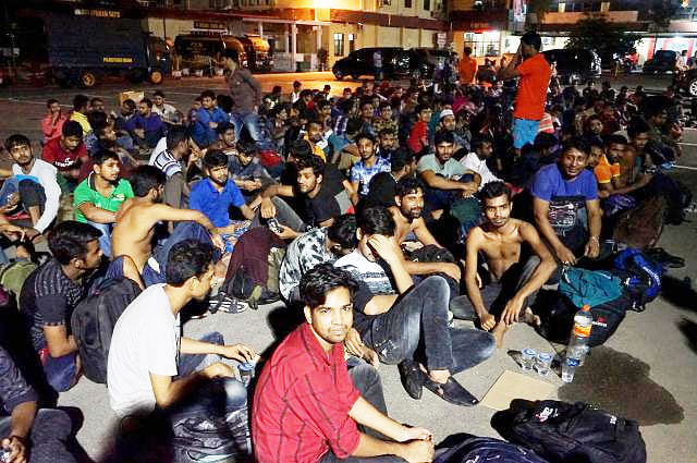 Bangladeshi nationals are seen gathered outside a police station following a raid on a shophouse in Medan on 6 February 2019. Photo : AFP