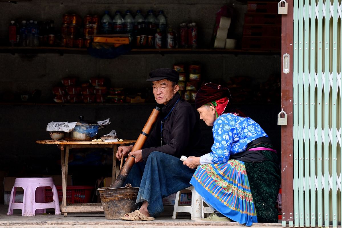 This picture taken on 29 October 2018 shows a Hmong shopkeeper waiting for customers at his shop in Dong Van district, northern Vietnam`s Ha Giang province. Photo: AFP