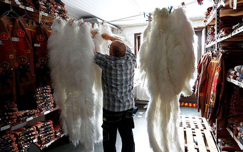 A worker hangs ostrich feathers to dry, worn on a hat by the “Gilles of Binche” performers during the Binche carnival, a UNESCO World Heritage event, in a shop in Binche, Belgium on 1 February 2019. Photo: Reuters