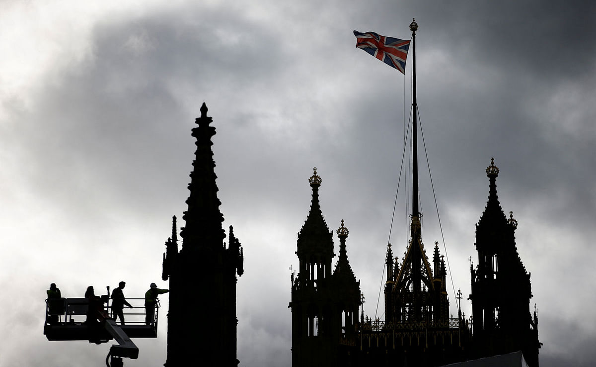 Workers using a crane can be seen inspecting part of the roof of the Houses of Parliament in London, Britain on 7 February 2019. Photo: Reuters
