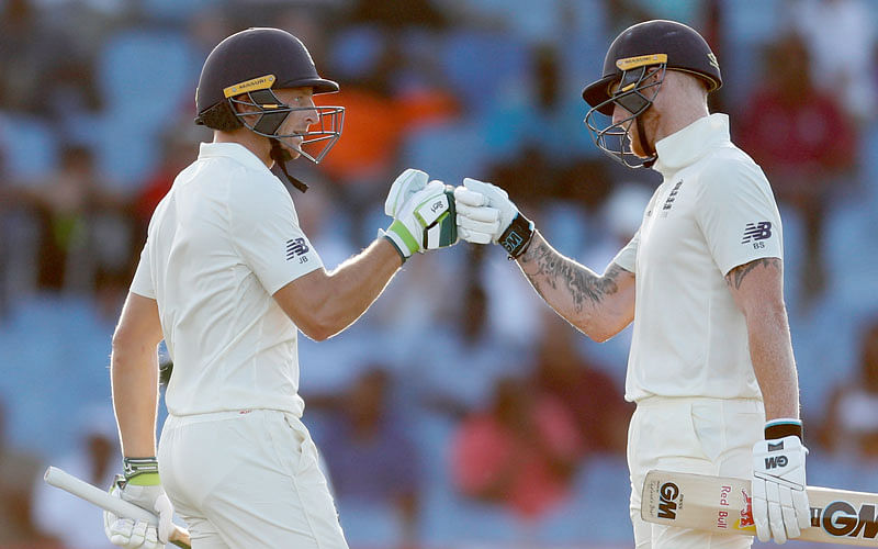England’s Jos Buttler celebrates a half century with Ben Stokes in Third Test against West Indies at Darren Sammy National Cricket Stadium, St Lucia on 9 February 2019. Photo: Reuters