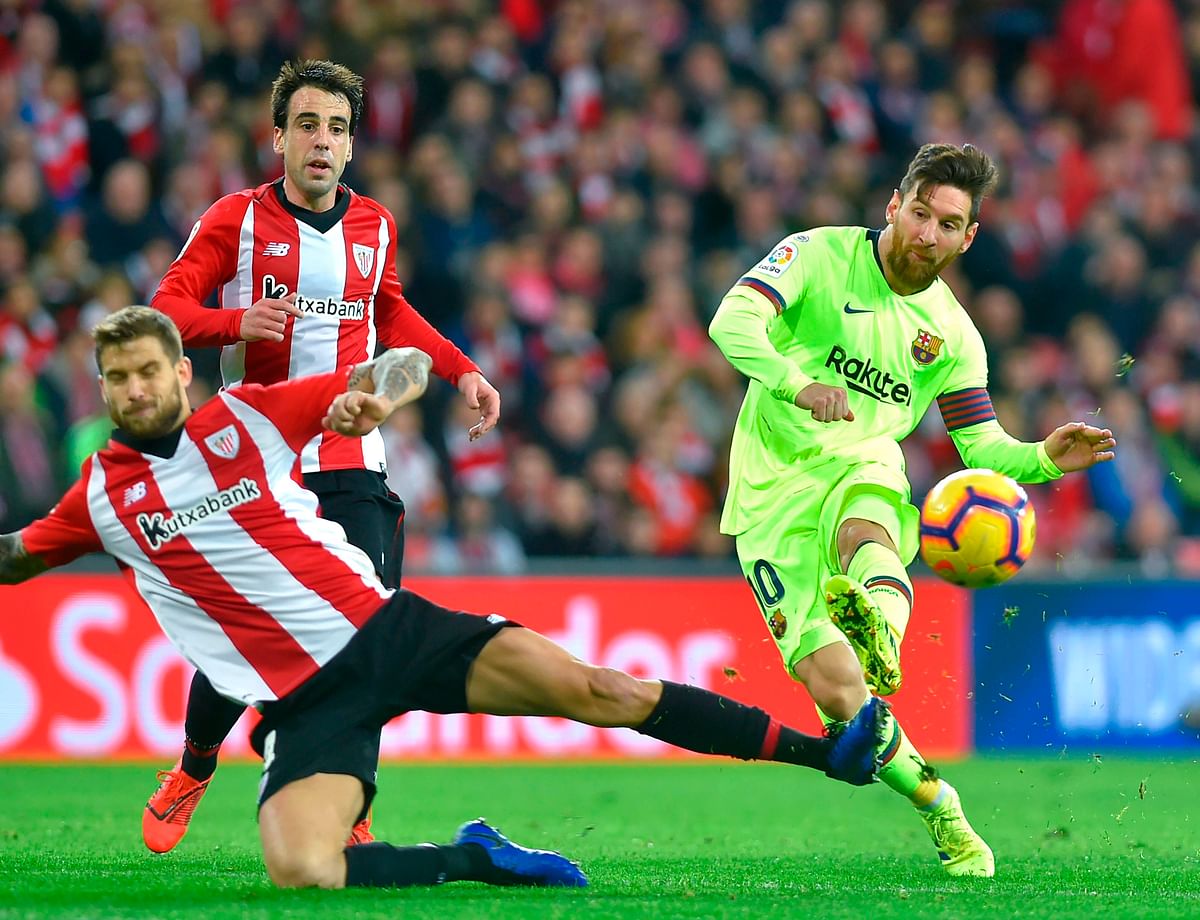 Barcelona`s Argentinian forward Lionel Messi (R) vies with Athletic Bilbao`s Spanish defender Inigo Martinez during the Spanish league football match Athletic Club Bilbao against FC Barcelona at the San Mames stadium in Bilbao on 10 February 2019. Photo: AFP