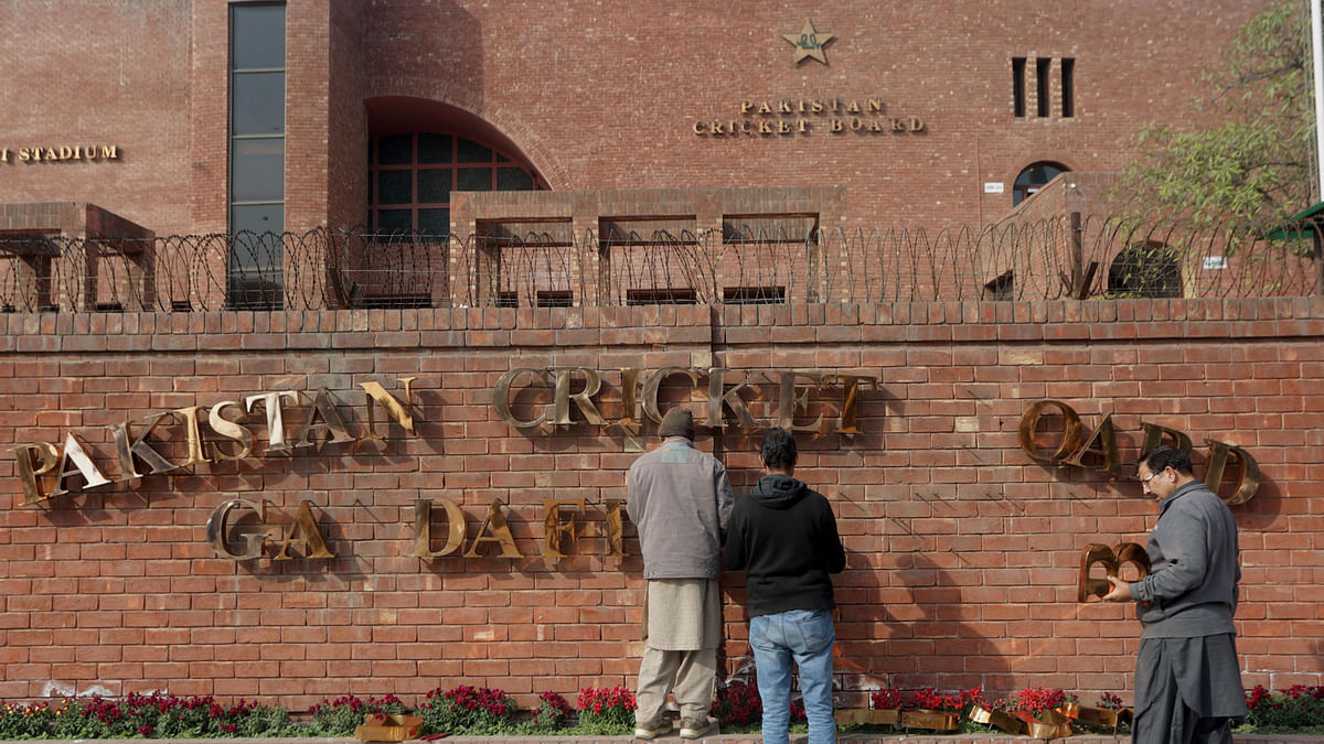 In this 10 February 2019, photo, Pakistani staff fix the name of Gadaffi stadium in preparation for the upcoming Pakistan Super League in Lahore, Pakistan. Photo: AP