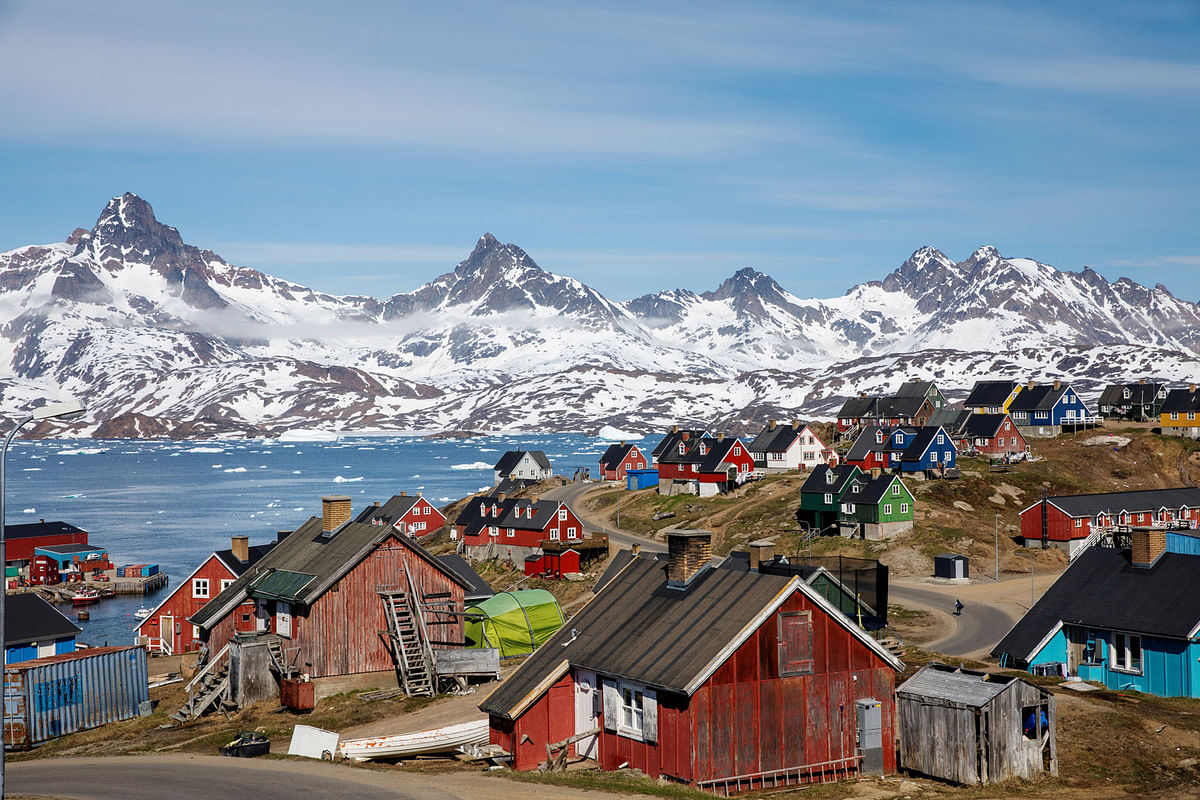 Snow covered mountains rise above the harbour and town of Tasiilaq, Greenland on 15 June, 2018. Reuters File Photo