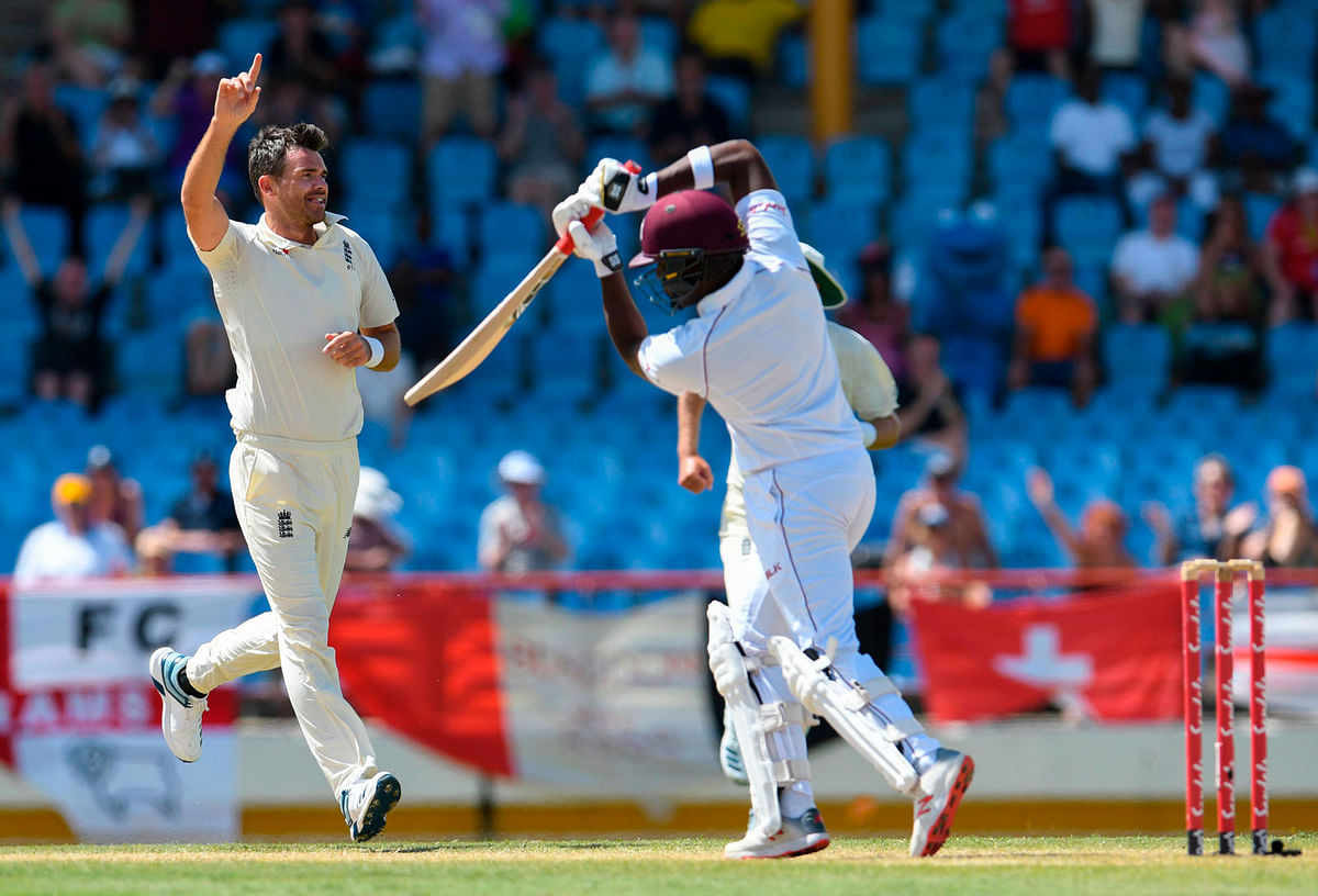 James Anderson (L) of England celebrates the dismissal of Darren Bravo (R) of West Indies during day 4 of the 3rd and final Test between West Indies and England at Darren Sammy Cricket Ground, Gros Islet, Saint Lucia, on 12 February 2019. Photo: AFP