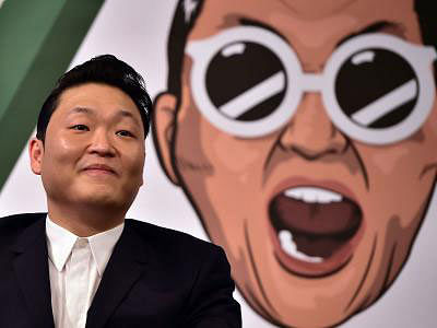 South Korean singer Psy, 37, smiles during a press conference to promote his seventh album at a hotel in Seoul on 30 November. Psy is set to release his first album on 1 December for more than three years, with the ‘Gangnam Style’ star vowing a return ‘to his roots’. Photo: AFP