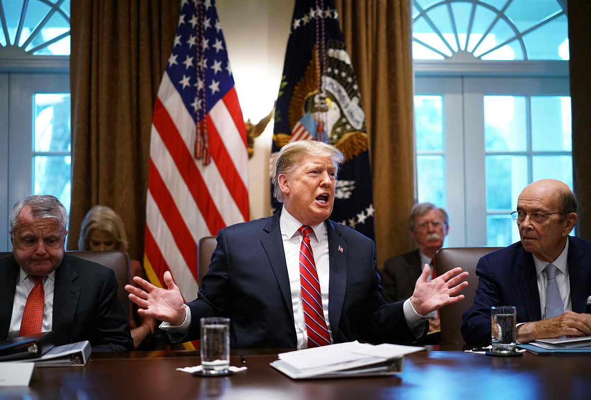 In this file photo taken on February 12, 2019 US President Donald Trump speaks during a cabinet meeting in the Cabinet Room of the White House in Washington, DC as Deputy Secretary of State John Sullivan (L) and Commerce Secretary Wilbur Ross(R) look on. Photo: AFP