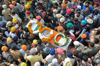 Family members and villagers carry the coffin of Indian Central Reserve Police Force (CRPF) trooper Sukhjinder Singh during the cremation ceremony at Gandiwind village, some 60 kms from Amritsar, on 16 February 2019, following an attack on a CRPF convoy in Kashmir. Thousands of mourners across several Indian cities 16 February attended funerals of soldiers killed in a deadly suicide bombing in Indian-administered Kashmir as a round-the-clock curfew remains in force in a part of the restive region. AFP: AFP