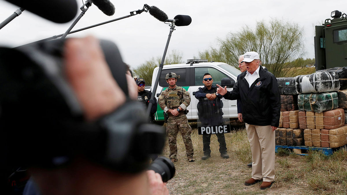 US president Donald Trump talks to the media as he stands with US Border Patrol agents on the banks of the Rio Grande river during his visit to the US - Mexico border in Mission, Texas, US, on 10 January 2019. Reuters File Photo