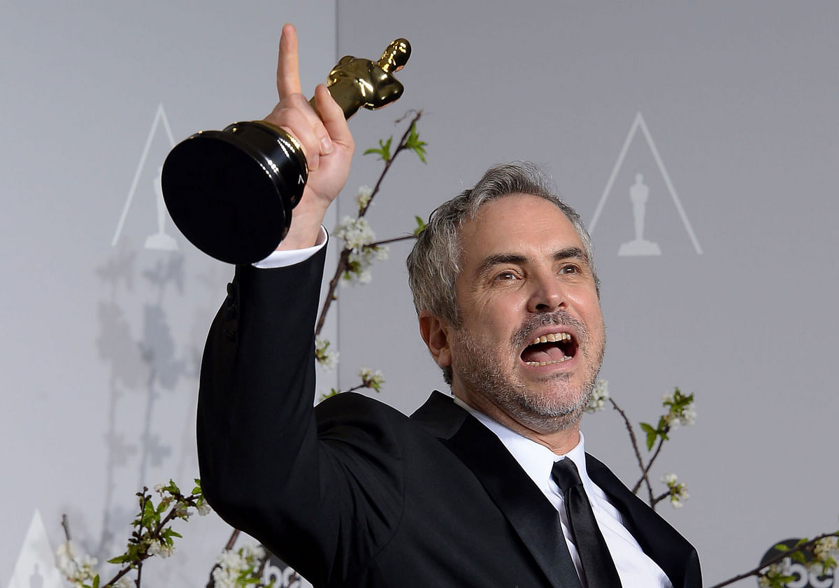 In this file photo taken on 02 March, 2014, director Alfonso Cuarón, winner of Best Achievement in Directing for `Gravity`, poses in the press room during the 86th Academy Awards in Hollywood, California. Photo: AFP