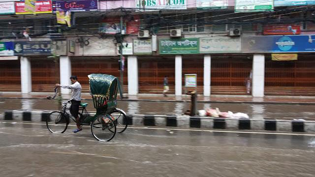Part of Dhaka`s Green Road went under water in a brief spell of light showers on Sunday morning. Photo: Mintu Hossain