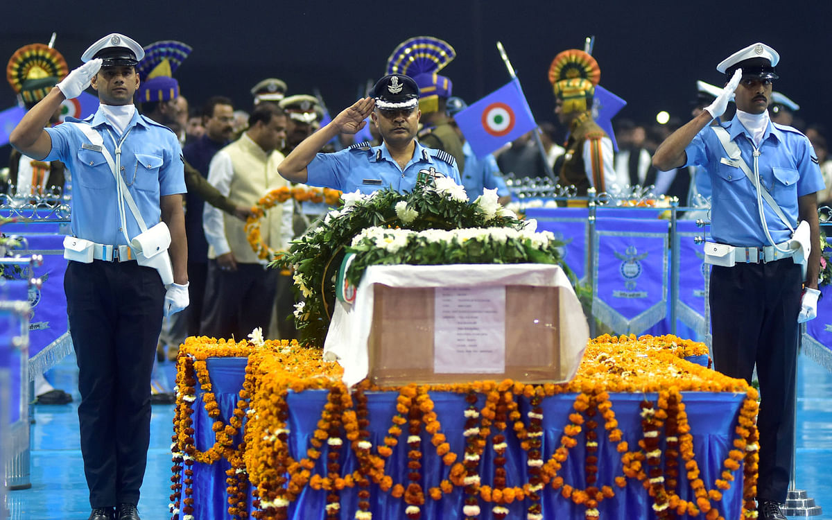 Indian Air Force officers pay tribute next to a coffin containing the remains of Maneswar Basumatary, a Central Reserve Police Force (CRPF) personnel who was killed after a suicide bomber rammed a car into the bus carrying CRPF personnel in south Kashmir on Thursday, at Air Force Station in Guwahati, India, on 16 February 2019. Photo: Reuters