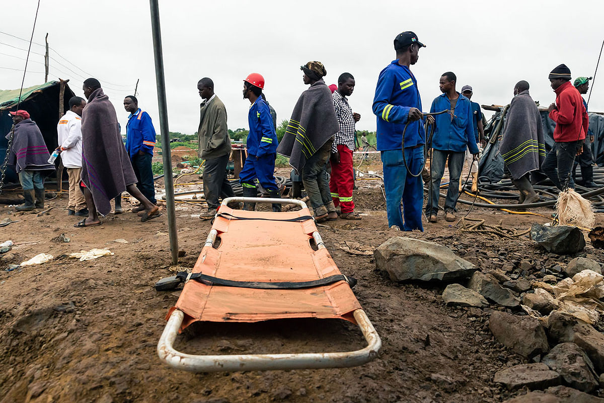 Men walk past a stretcher during an ongoing rescue and recovery operation at the flooded Cricket gold mine near Kadoma, Zimbabwe, on 17 February 2019. Photo: AFP