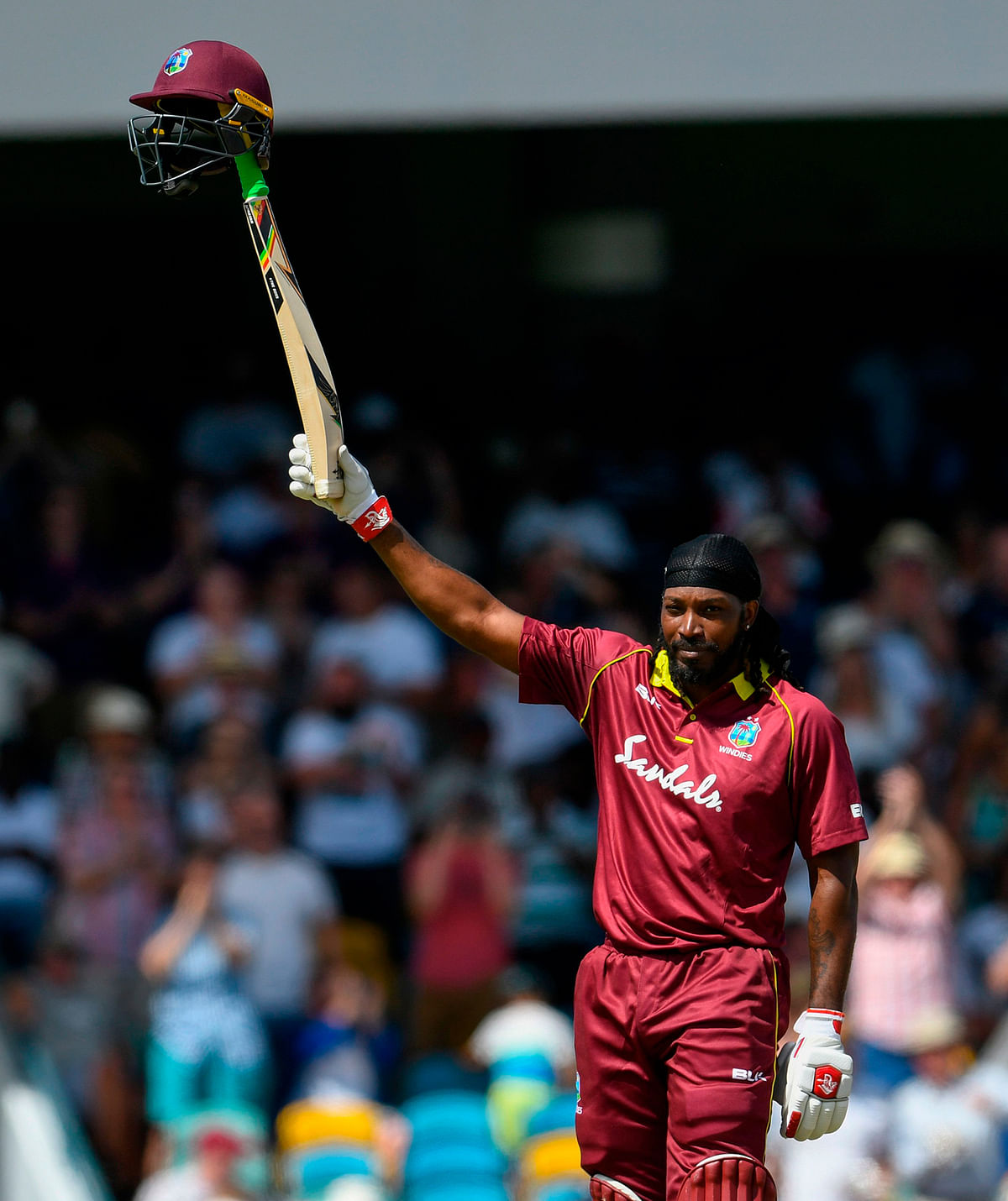 Chris Gayle (R) of West Indies celebrates his century during the 1st ODI between West Indies and England at Kensington Oval, Bridgetown, Barbados, on 20 February 2019. Photo: AFP