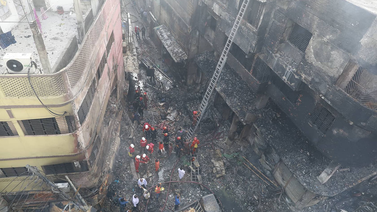 Firefighters are working in the burnt building in Chawkbazar area of Old Dhaka on Thursday morning. Photo: Prothom Alo