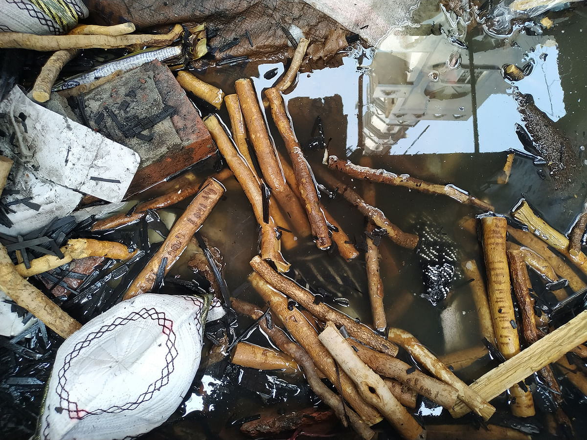 A cap and miswak (teeth cleaning twig) is seen in the wreckage of a warehouse. Photo: Galib Ashraf