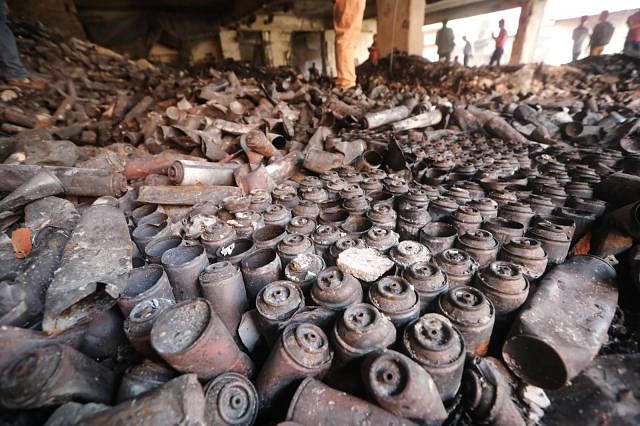 Destroyed cans to refill gas lighters are seen inside the buildings damaged by a devastating fire in Churihatta, Chawakbazar, Dhaka. Photo: Abdus Salam