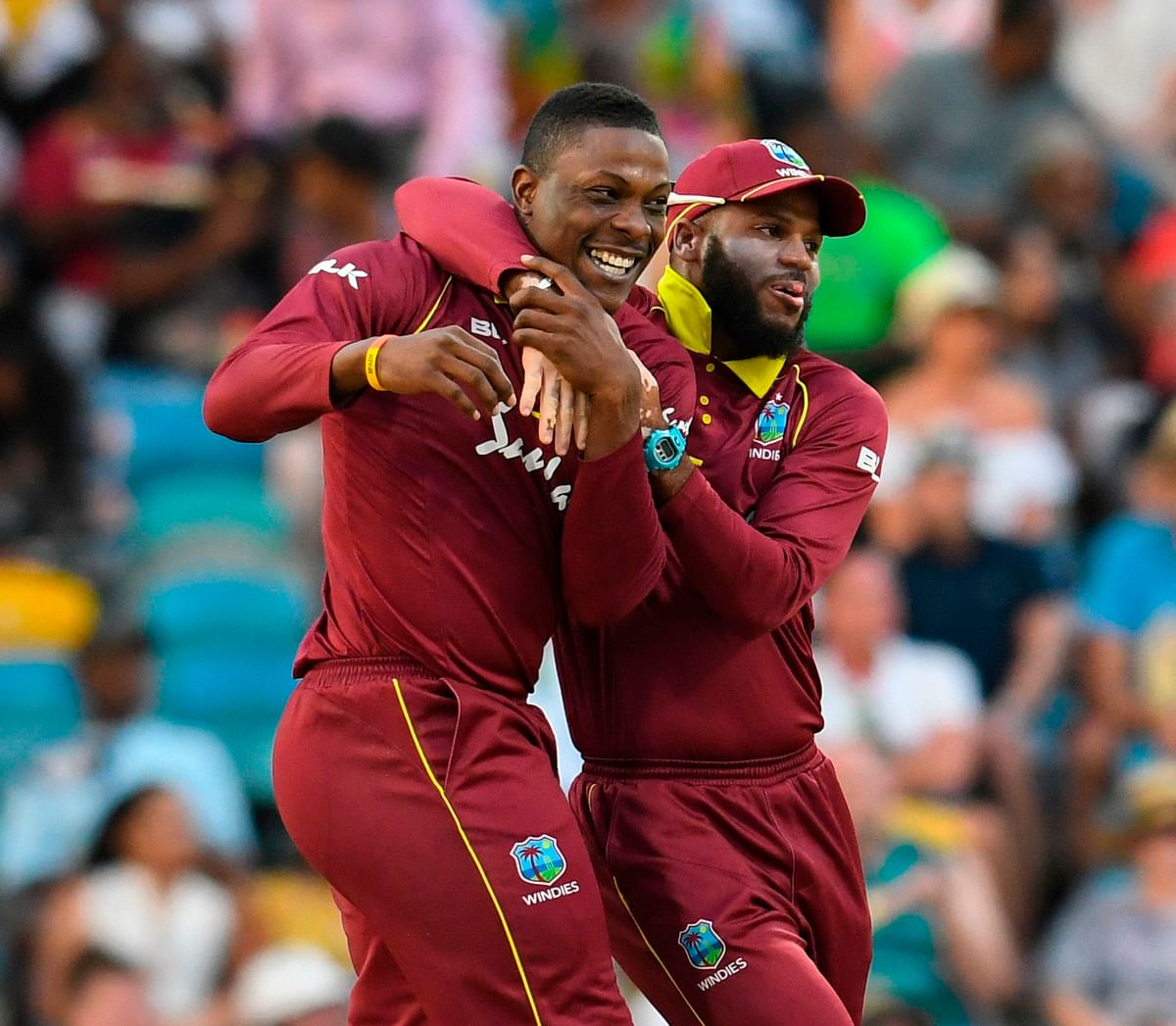 Sheldon Cottrell (L) and John Campbell (R) of West Indies celebrate the dismissal of Eoin Morgan of England during the second ODI between West Indies and England at Kensington Oval, Bridgetown, Barbados, on 22 February 2019. Photo: AFP