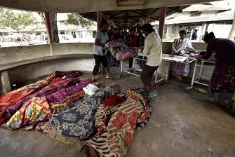 The dead bodies of people killed by drinking toxic bootleg liquor are gathered together at Kushal Konwar Civil Hospital in Golaghat district in the northeastern Indian state of Assam on 23 February 2019. Sixty-nine workers have died and at least 200 others have been hospitalised in northeastern India after drinking toxic liquor, officials said 23 February, in the latest case of alcohol poisoning in the country. Photo: AFP