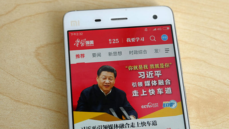 This photo illustratration taken on 20 February 2019 shows a phone app called “Xuexi Qiangguo” or “Study to make China strong” with an image of China’s president Xi Jinping in Beijing. A propaganda app that puts China’s powerful president Xi Jinping in anyone’s pockets has become a hit in the country—with a helpful nudge from Communist Party officials. Photo: AFP