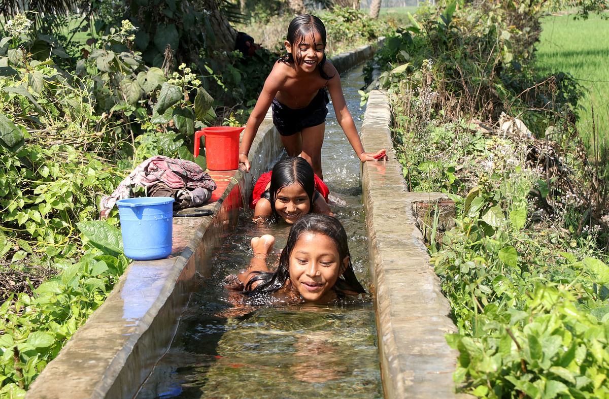 Children playing in water along drains used for agriculture at Shajahanpur, Bogura on 25 February. Photo: Soel Rana