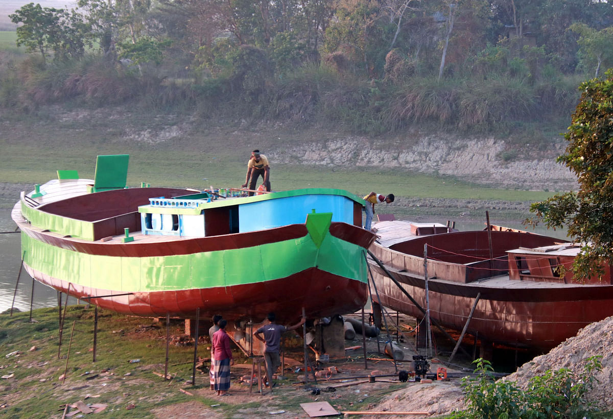 Workers busy in making boats ahead of the rainy season at Samaurakandi in Sylhet on 26 February. Photo: Anis Mahmud