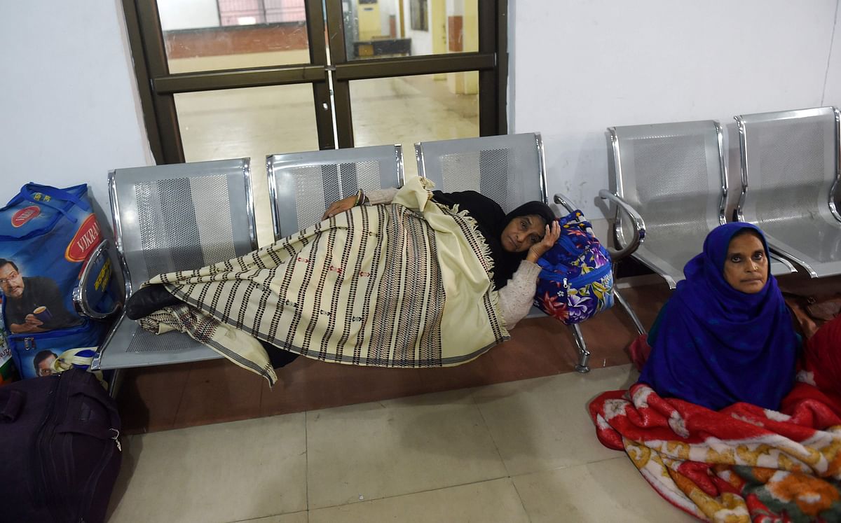 Stranded Indian passengers travelling with the Samjhauta Express, also called the Friendship Express that runs between Delhi and Attari in India and Lahore in Pakistan, sit and lay at the waiting area at Lahore railway station on 28 February 2019, as Pakistani authorities suspended the train service temporarily. Photo: AFP