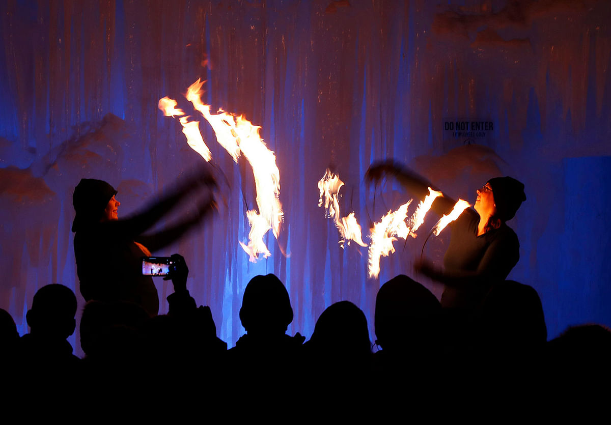 In this 26 January 2019 photo, fire dancers perform at Ice Castles in North Woodstock, NH. The winter wonderland is one of six in North America. Photo: AP