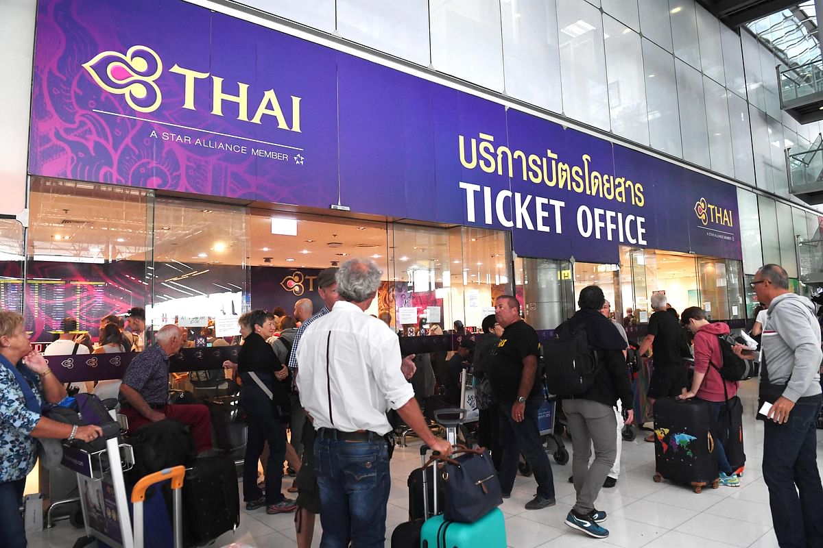 Stranded passengers wait outside the Thai Airways ticket counter at the Suvarnabhumi International Airport in Bangkok on 28 February 2019. Photo: AFP