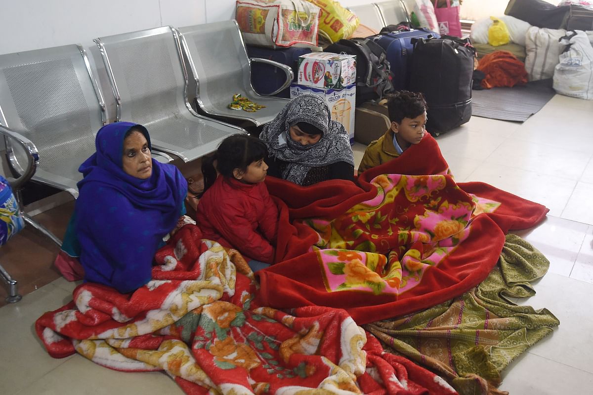 Stranded Indian passengers travelling with the Samjhauta Express, also called the Friendship Express that runs between Delhi and Attari in India and Lahore in Pakistan, sit at the waiting area at Lahore railway station on 28 February 2019, as Pakistani authorities suspended the train service temporarily. Photo: AFP