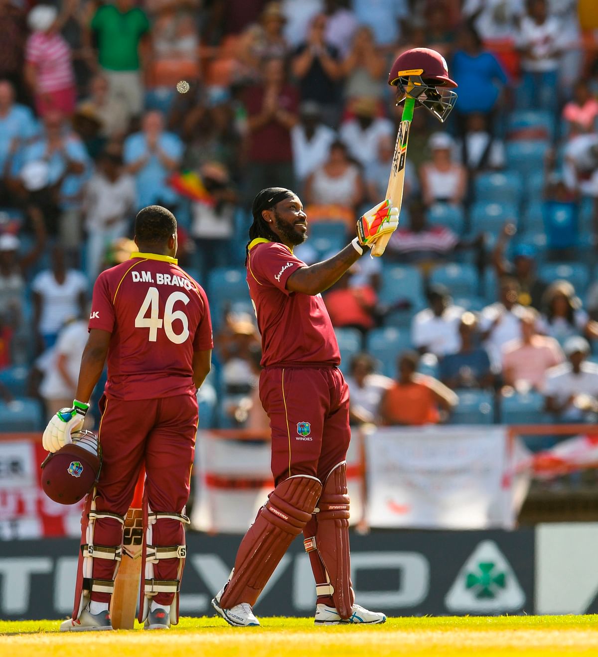 Chris Gayle (R) of West Indies celebrates his century during the 4th ODI between West Indies and England at Grenada National Cricket Stadium, Saint George`s, Grenada, on 27 February 2019. Photo: AFP