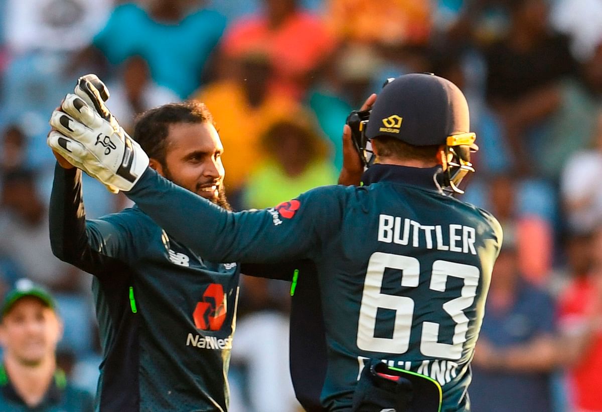 Adil Rashid (L) and Jos Buttler (R) of England celebrate the dismissal of Devendra Bishoo of West Indies during the 4th ODI between West Indies and England at Grenada National Cricket Stadium, Saint George`s, Grenada, on 27 February 2019. Photo: AFP