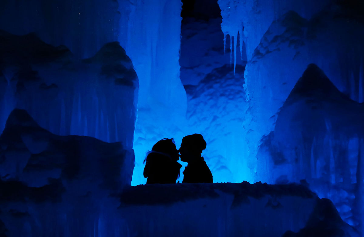 In this 26 January 2019 photo, a couple enjoy the Ice Castles in North Woodstock, NH. `It`s a really popular date night spot,` said castle builder Matt Pasciuto. `I can`t tell you how many marriage proposals I`ve seen so far in the castle.` Photo: AP