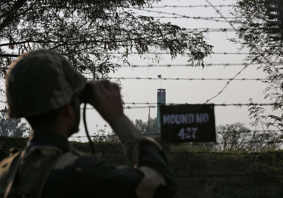 An India`s Border Security Force (BSF) soldier keeps vigil during patrol along the fenced border with Pakistan in Ranbir Singh Pura sector near Jammu on 26 February 2019. Reuters File Photo