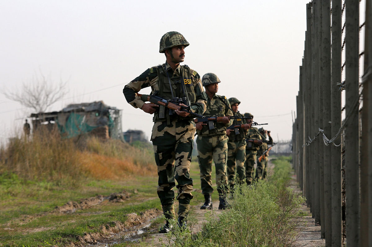 India`s Border Security Force (BSF) soldiers patrol along the fenced border with Pakistan in Ranbir Singh Pura sector near Jammu on 26 February 2019. Reuters File Photo