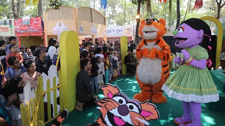 Haloom and Tuktuki, characters of a popular TV show Sisimpur, perform for the children who came to buy books in Ekushey book fair on 1 March. Photo: Dipu Malakar