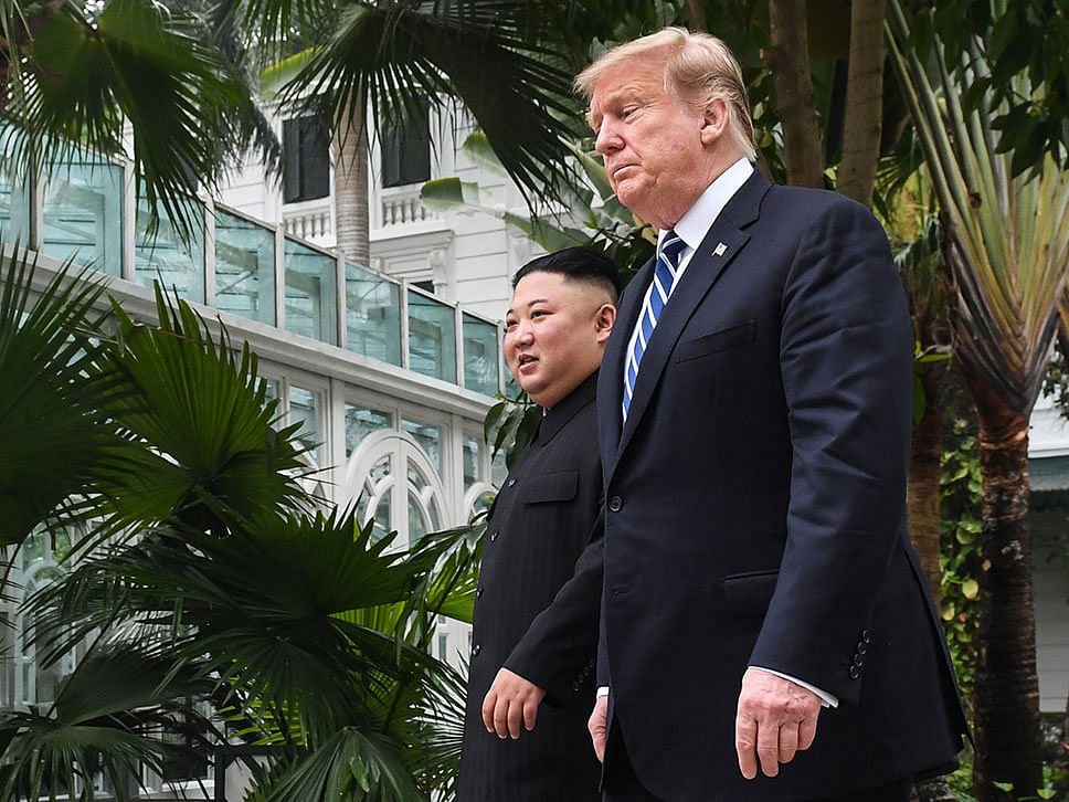 US president Donald Trump (R) walks with North Korea`s leader Kim Jong Un during a break in talks at the second US-North Korea summit at the Sofitel Legend Metropole hotel in Hanoi on 28 February. Photo: AFP